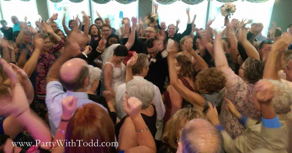 Guests dance with the bride and groom