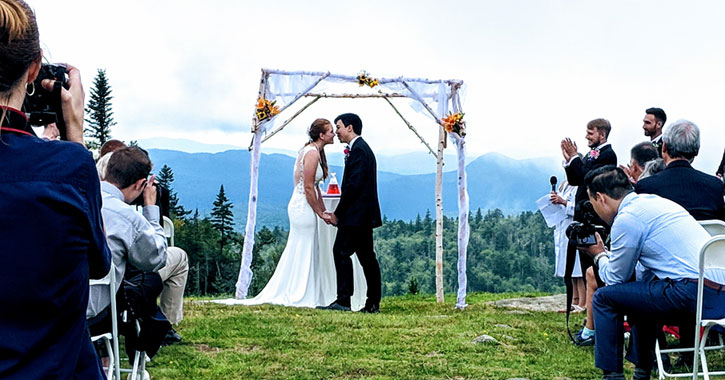 bride and groom kissing at the alter