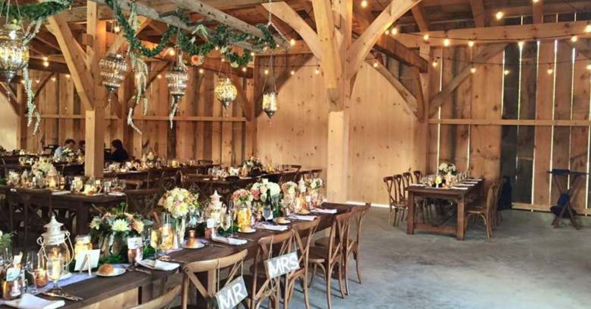 reception area in a barn with tables and chairs set up