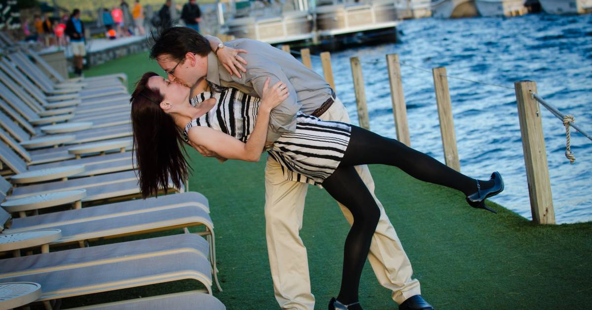 couple kisses on docks